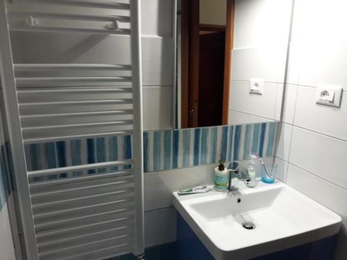 a bathroom with a white sink and a mirror at Casa Vacanza La Zanca in Zanca