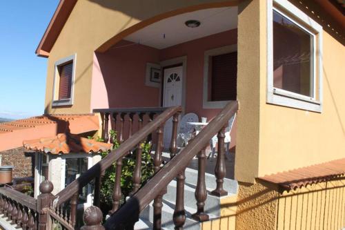 a house with a wooden railing on a balcony at Casa da Juraci in Sabrosa