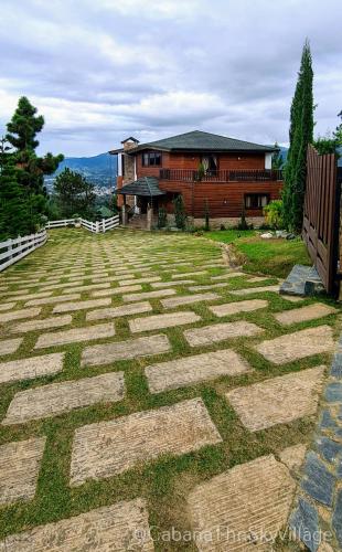 a stone walkway in front of a house at Villa The sky village in Jarabacoa