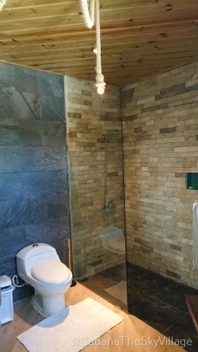 a bathroom with a toilet and a shower at Villa The sky village in Jarabacoa