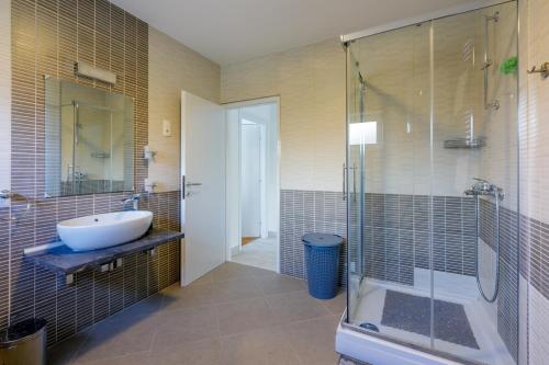 a bathroom with a sink and a shower at Apartment Tus A1 in Crikvenica