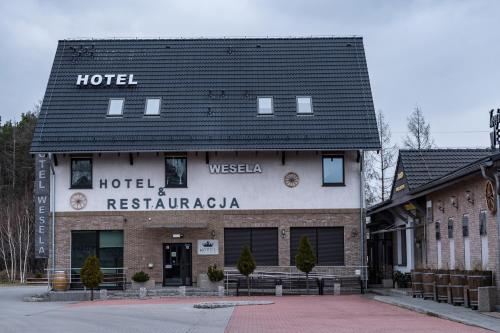 a hotel building with a black roof at Hotel Zajazdu w Ostrzeszowie in Ostrzeszów