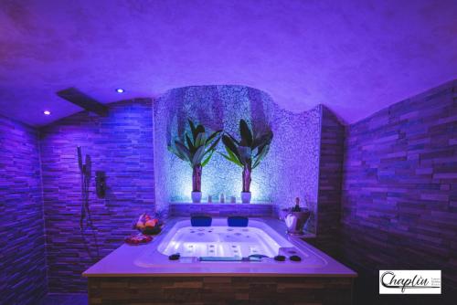 a large bathroom with a tub with purple lighting at CHAPLIN Luxury Holiday House in Viterbo