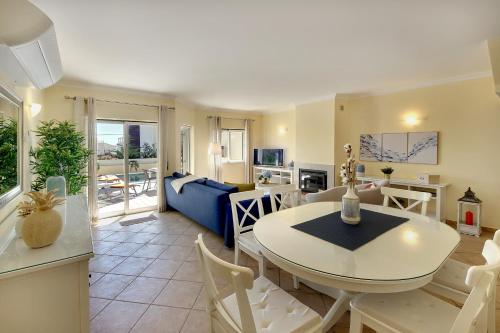 a dining room and living room with a table and chairs at Eagle Eye Villa in Albufeira