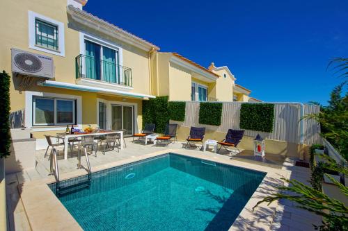 a villa with a swimming pool in front of a house at Eagle Eye Villa in Albufeira