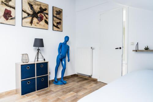 een blauwe mannequin op een dressoir in een kamer bij Lovely, Colourful Holiday Home for Small Families in Érezée