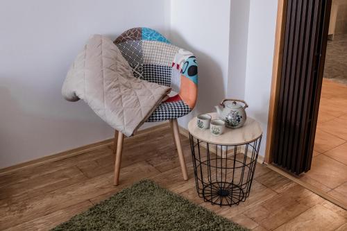 a chair sitting in a room with a table at Penzion Pohoda in Frymburk