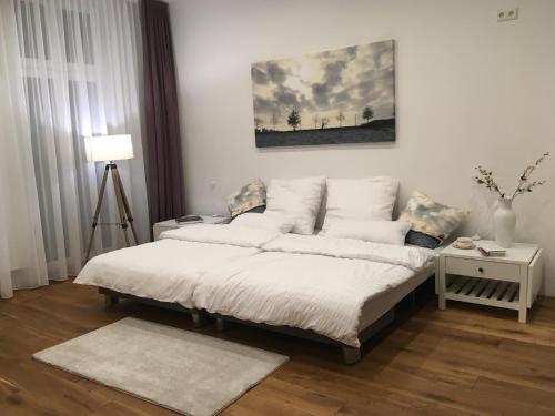a bedroom with a bed with white pillows at City-Apartment Ohligs in Solingen