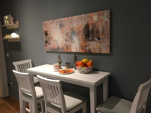 a white table with a bowl of fruit on it at City-Apartment Ohligs in Solingen