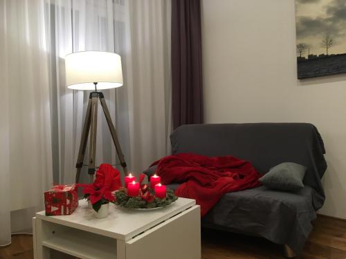 a room with a bed with a table with candles at City-Apartment Ohligs in Solingen