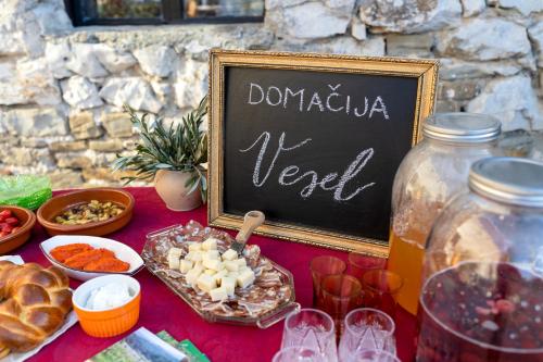 a table with a chalkboard sign and some food at Domačija Vesel in Trebnje