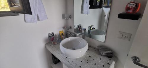 a bathroom with a bowl sink and a mirror at Ocean Breeze Cove - Luxury Retreat in Pedasí Town