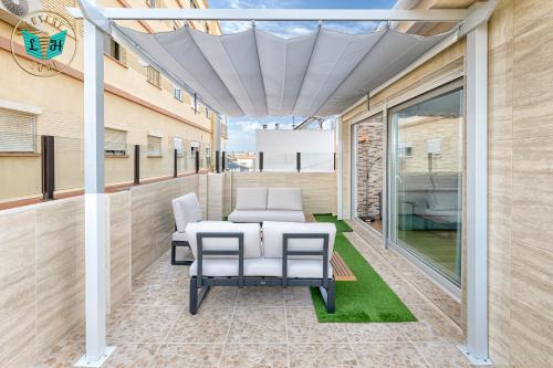 a patio with a table and chairs on a building at Luxury Home With Terrace in Málaga