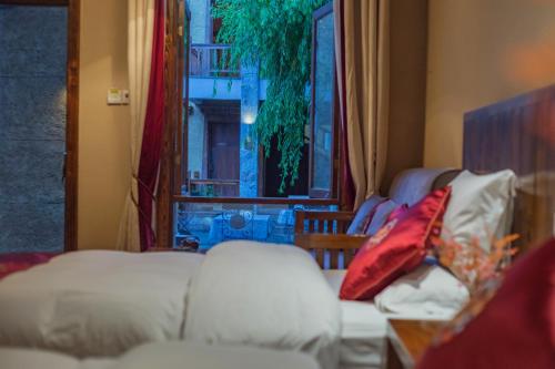 a living room with a couch and a window at Arro Khampa By Zinc Journey Shangri-la in Shangri-La