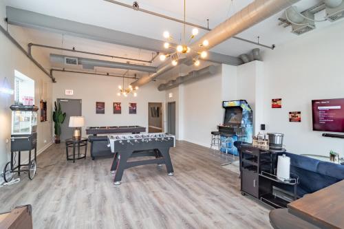 a room with a ping pong table and a video game at Penthouse of Joy with over 4000 games! in Chicago