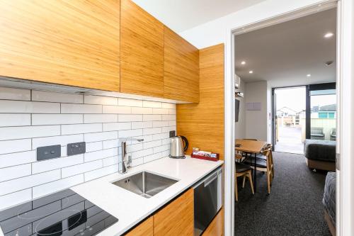 a kitchen with a sink and a counter top at The Strand in New Plymouth