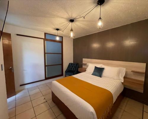 Postel nebo postele na pokoji v ubytování Hotel Orquídea