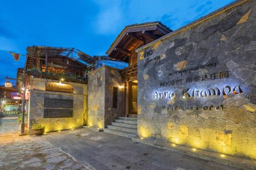 a building with a sign on the side of it at Arro Khampa By Zinc Journey Shangri-la in Shangri-La