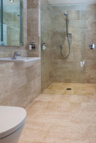 a bathroom with a shower and a toilet and a sink at The Borough Lancaster in Lancaster