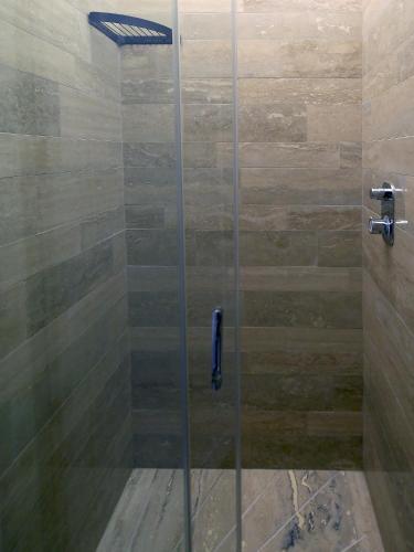 a shower with a glass door in a bathroom at Piccolo di Piazza di Spagna Suites in Rome