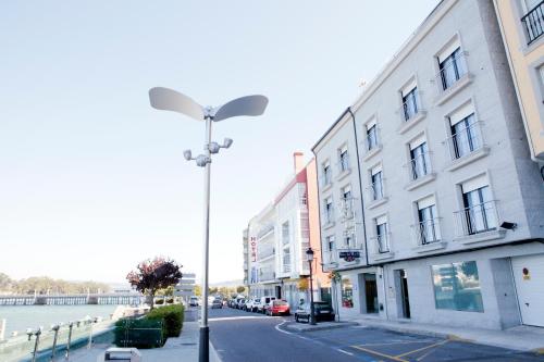 a street light on the side of a street next to a building at Hotel Brisa del Mar in O Grove