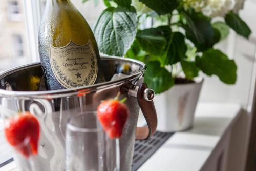 a bottle of champagne in a bucket next to strawberries at The Borough Lancaster in Lancaster