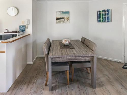 
a dining room table and chairs in a small room at Kings Way Apartments in Caloundra
