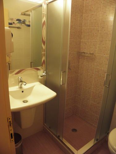 a bathroom with a shower and a sink at Pension Votsi in Votsi