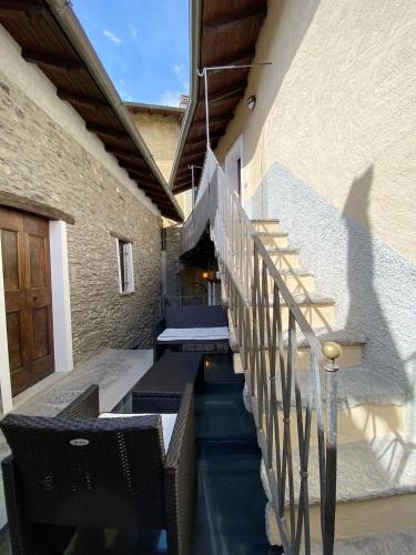 a set of stairs leading up to a building at Independent Stone House with Lake View in Musso