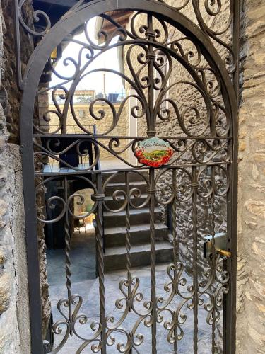 an iron gate with a staircase behind it at Independent Stone House with Lake View in Musso