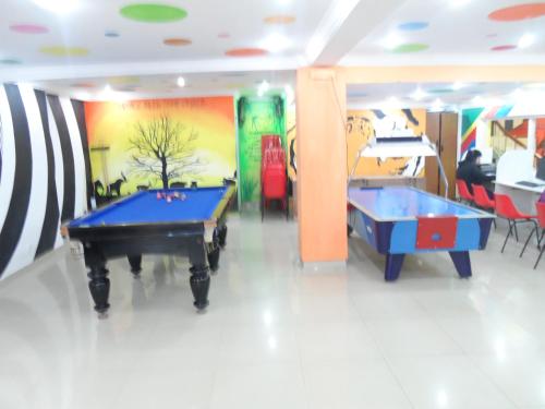 two pool tables in a room with colorful walls at Sterling Kodai Lake in Kodaikānāl