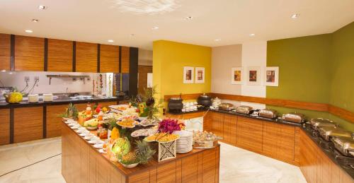 a large kitchen with a buffet with a lot of food at Sterling Kodai Lake in Kodaikānāl