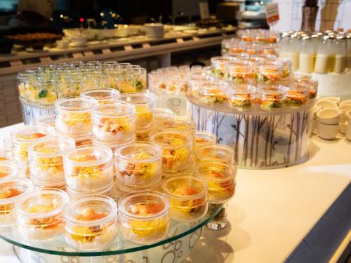a bunch of glasses filled with food on a counter at Lake Shikotsu Tsuruga Resort Spa Mizu no Uta in Chitose