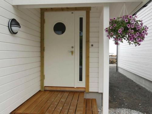 a front door of a house with a wreath of flowers at 6 person holiday home in Åram-By Traum in Sandvik