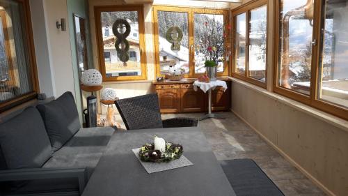 a living room with a couch and a table with a candle at Haus Binder in Ried im Zillertal