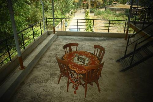 a table and chairs sitting on top of a patio at Reunion Villa Abode in Udupi