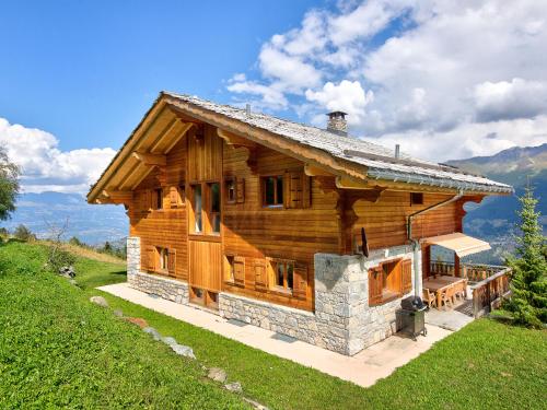 a log house on a hill with mountains in the background at Chalet in Les Collons near Ski Slope in Les Collons