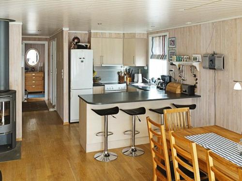 KjellsundにあるFour-Bedroom Holiday home in Gurskøy 1のキッチン(カウンター、テーブル、椅子付)