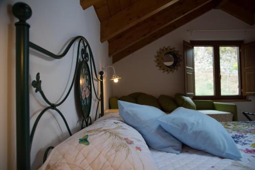 a bedroom with a bed with blue pillows at San Giacomo Relais in Furore