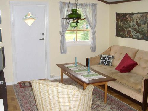 a living room with a couch and a table at 5 person holiday home in MELLBYSTRAND in Mellbystrand