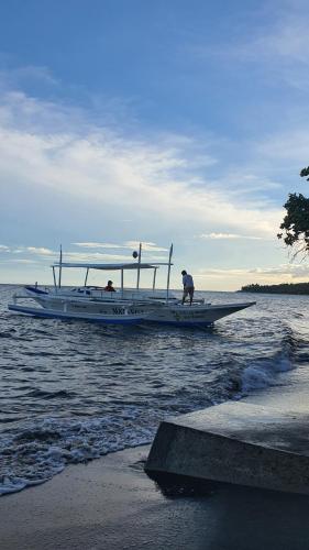 two people on a boat in the water at A Villas Resort & Restaurant in Zamboanguita