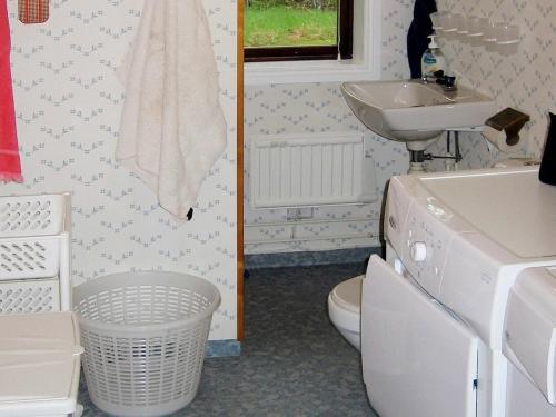 a small bathroom with a sink and a toilet at Four-Bedroom Holiday home in Åtvidaberg in Yxnerum