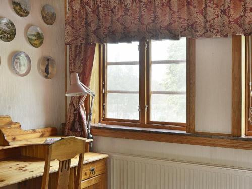 a window in a room with a desk and a table at 17 person holiday home in MELLERUD-By Traum in Dals Rostock