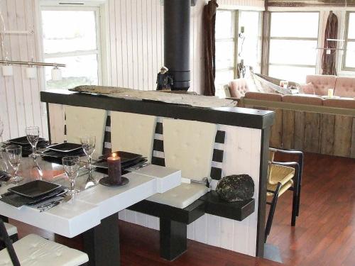 a dining room with a table with a candle on it at Three-Bedroom Holiday home in Kalvåg in Kalvåg