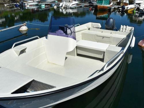 a white boat is docked in the water at 9 person holiday home in Farstad-By Traum in Farstad