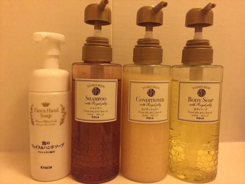 a group of four bottles of soap and liquid at Dormy Inn Hiroshima in Hiroshima