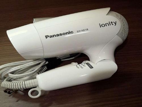 a white hair dryer sitting on top of a table at Dormy Inn Hiroshima in Hiroshima