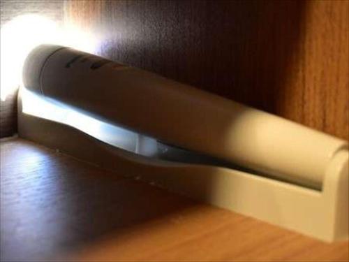 a remote control sticking out of a wooden wall at Dormy Inn Hiroshima in Hiroshima