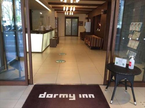 an empty hallway of a restaurant with a table and a glass door at Dormy Inn Hiroshima in Hiroshima