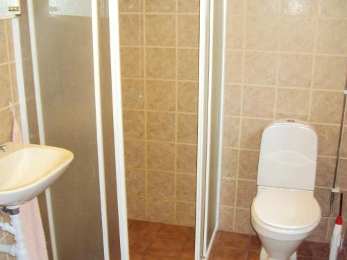 a bathroom with a toilet and a sink at Two-Bedroom Holiday home in Lessebo in Skruv